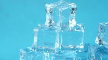 Close up of many ice cubes on blue background video