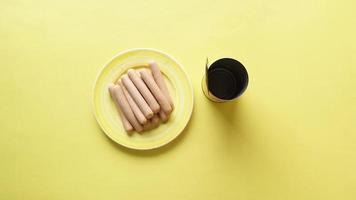 Top view of canned sausage food on yellow background video