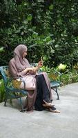 Young muslim woman using smart phone in a park video