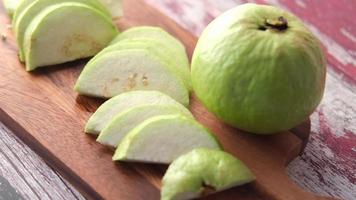 Cutting slice of guava on a chopping board . video