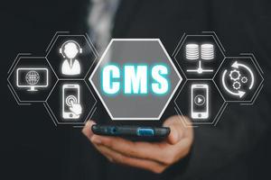 CMS, Content management system concept, Person hand using smart phone with Content management system icon on virtual screen background, business web computer website administration. photo