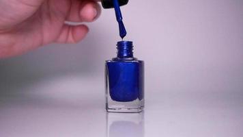 Blue nail polish on white background video
