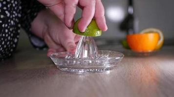 Squeeze lime juice close up with a glass squeezer video