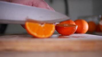 Cut tangerine close-up on a wooden board video