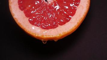 Liquid honey dripping from grapefruit video