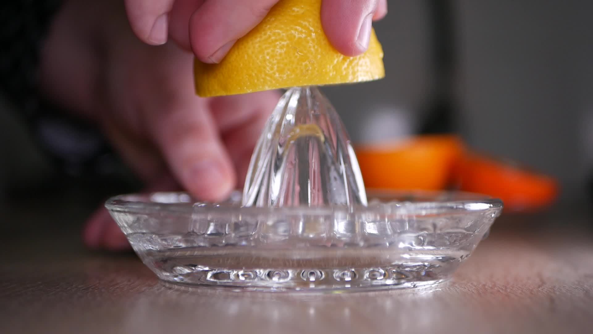 Squeeze the juice of a lemon closeup with a glass squeezer 20415742