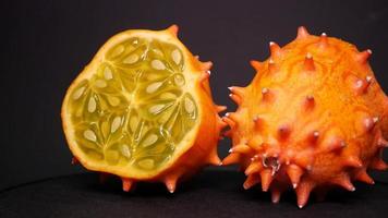 Ripe kiwano on a black background twirl video