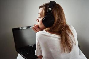 Woman listening online course in headphones, distance education photo
