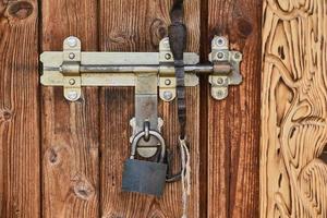 Old vintage wooden door with padlock photo