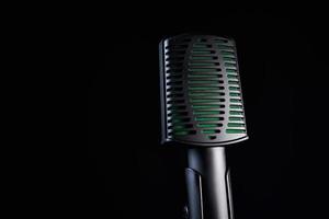 Close up studio microphone on black background photo