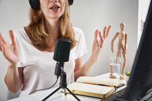 Woman records online podcast at home, podcasting concept photo