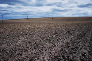 Plowed field in a spring day. Plowed soil for planting crops photo