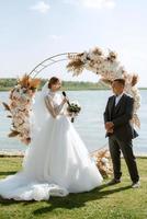 wedding ceremony of the newlyweds on the pier photo