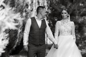 young couple the groom in a plaid suit and the bride in a chic white dress photo