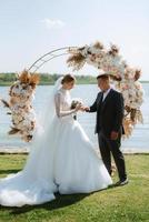 wedding ceremony of the newlyweds on the pier photo