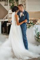 the first dance of the bride and groom inside a restauran photo