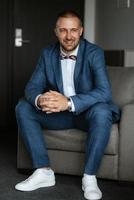 portrait of smiling groom with beard photo