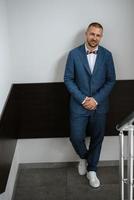 portrait of smiling groom with beard photo