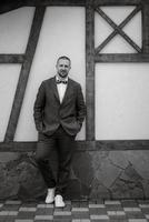 portrait of smiling groom with beard photo