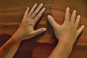 Hands on sand of Antelope Canyon photo