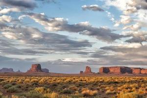 Monument Valley view on cloudy sky background photo