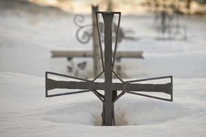 cemetery cross covered by snow photo