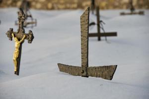 cemetery cross covered by snow photo