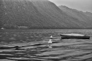 covered boat in a lake photo