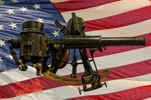 Old Antique Sextant on american flag background photo