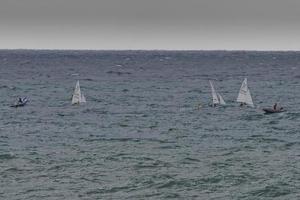 Sea Storm while regatta small ship are rolling photo