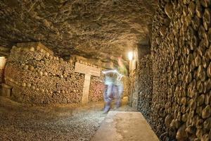 a ghost shape inside Paris Catacombs Skulls and bones photo