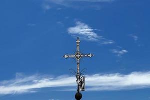 Iron Christian cross on the deep blue sly background photo