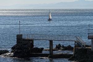 pier and sail boat photo