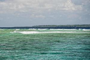 Waves on the reef in tropical paradise photo
