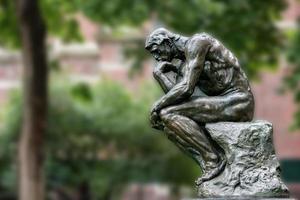 Thinker copper statue at university philosophy building photo