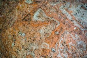 Red abstract surface of the rock in close up for background. photo