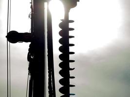 Close-up Silhouette of Excavator hydraulic drilling machine at a Construction site. photo