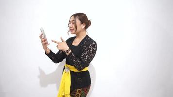 un asiático mujer participación un célula teléfono video
