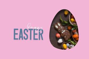 Happy Easter text and cut out Easter egg and chocolate bunny and eggs.  Happy Easter greeting card photo