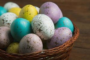 banner. Easter frame with eggs and feathers on a blue wooden background. Minimal concept. View from above. Card with copy space for text. photo