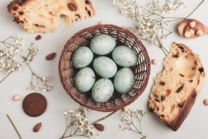 banner. Easter frame with eggs and feathers on a blue wooden background. Minimal concept. View from above. Card with copy space for text. photo