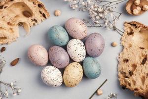 banner. Easter frame with eggs and feathers on a blue wooden background. Minimal concept. View from above. Card with copy space for text. photo