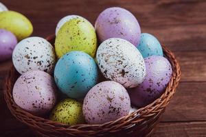 banner. Easter frame with eggs and feathers on a blue wooden background. Minimal concept. View from above. Card with copy space for text. photo