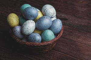 banner. Easter frame with eggs and feathers on a blue wooden background. Minimal concept. View from above. Card with copy space for text. photo