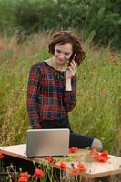 Beautiful woman or business woman talking on a cell phone outside. Outdoor portrait of a beautiful happy businesswoman talking on cell phone. photo