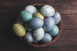 banner. Easter frame with eggs and feathers on a blue wooden background. Minimal concept. View from above. Card with copy space for text. photo
