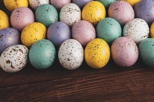 banner. Easter frame with eggs and feathers on a blue wooden background. Minimal concept. View from above. Card with copy space for text. photo