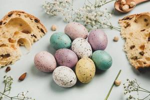 banner. Easter frame with eggs and feathers on a blue wooden background. Minimal concept. View from above. Card with copy space for text. photo