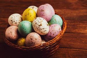 banner. Easter frame with eggs and feathers on a blue wooden background. Minimal concept. View from above. Card with copy space for text. photo
