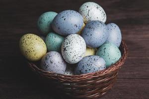 banner. Easter frame with eggs and feathers on a blue wooden background. Minimal concept. View from above. Card with copy space for text. photo